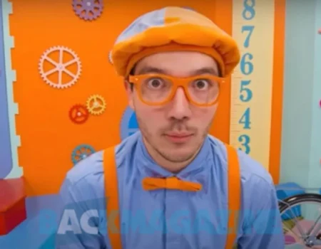 Clayton Grimm smiling in a colorful outfit, representing his role as Blippi with a $1.5 million net worth.