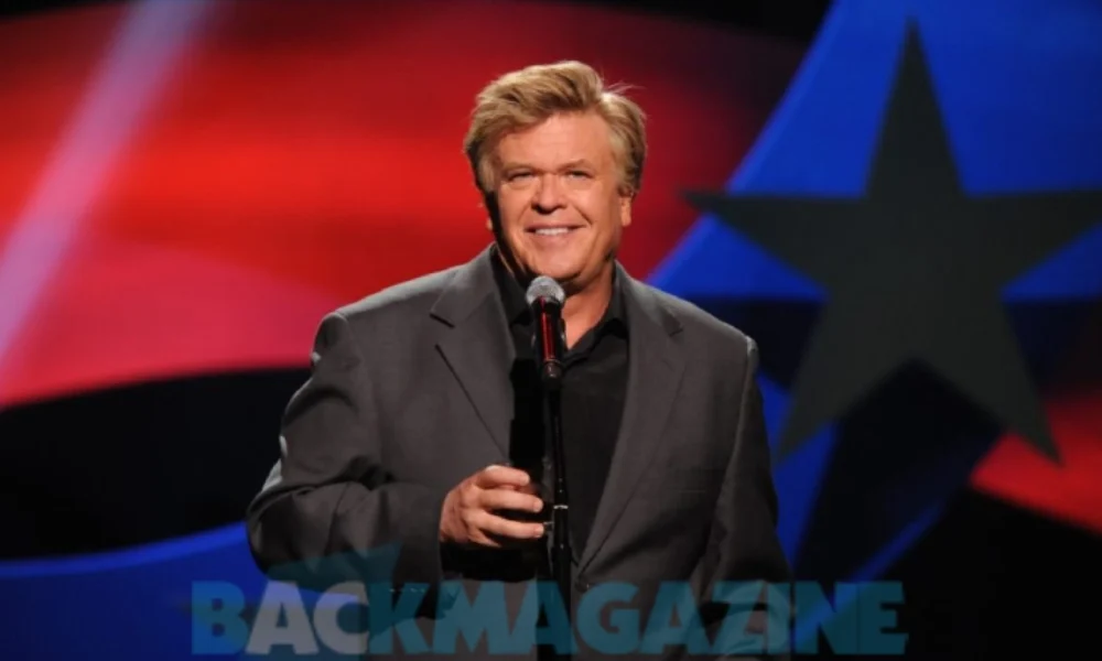 Ron White performing stand-up comedy while holding a cigar