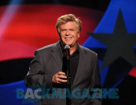 Ron White performing stand-up comedy while holding a cigar